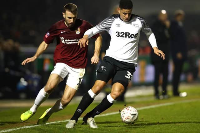 Andy Williams keeps a close eye on Derby's Curits Davies