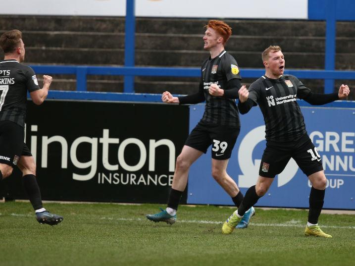 Nicky Adams and Sam Hoskins celebrate with goalscorer Callum Morton. Pictures: Pete Norton