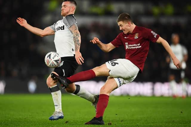 Scott Wharton clears the danger under pressure from Jack Marriott (Picture: Clive Masaon)