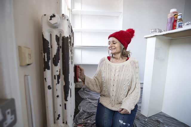 Karen pictured decorating one of the 30 rooms that needs sprucing up