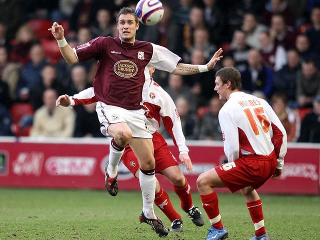 Ryan Gilligan battles for possession in midfield