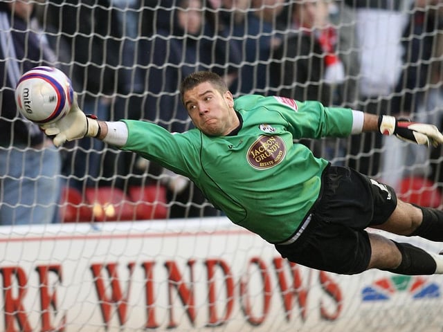 Mark Bunn makes a finger-tip save
