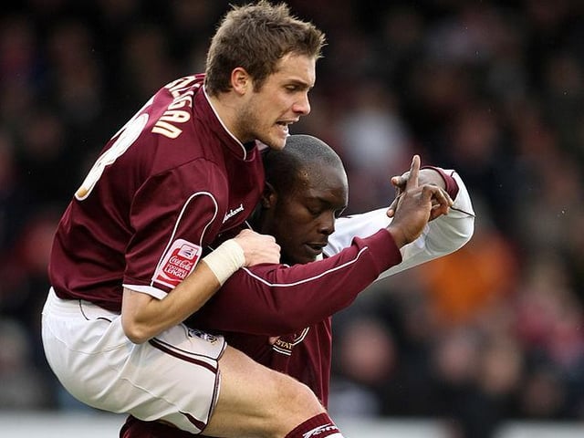 Ryan Gilligan congratulates Adebayo Akinfenwa after he scored his first goal