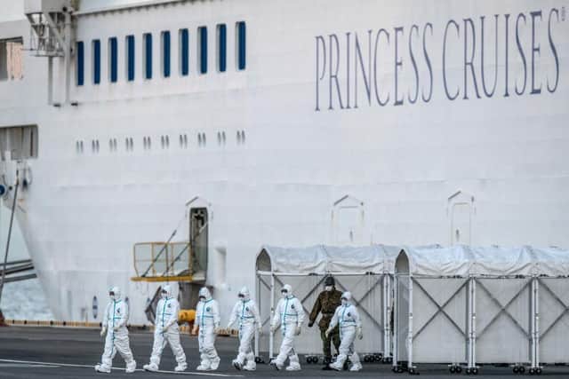 Health officials leave the quarantined Diamond Princess. Photo by Carl Court/Getty Images.