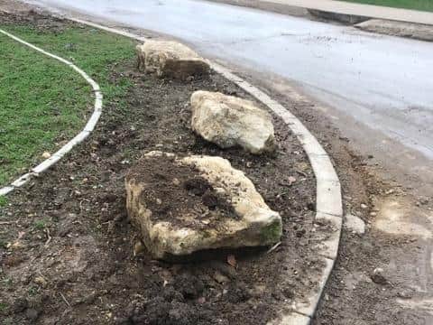 Several boulders have been placed on a grass verge on Sharpe Street in the Oak View housing development in Towcester to stop motorists from using it