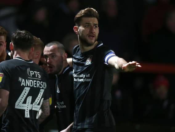 Charlie Goode joins the celebrations after Ryan Watson's early opener at Whaddon Road. Picture: Pete Norton