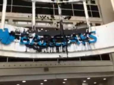 Protesters spread dye over the Barclays sign inside the building