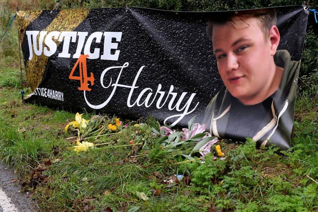 The poster and floral tribute to Harry Dunn on the B4031 where the crash happened