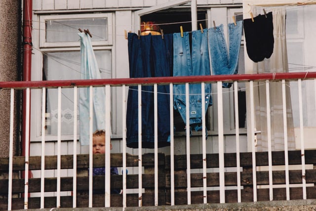 A fantastic photo from snapper Bruce Rollinson of a youngster captured behind the railings in a flat in Seacroft in the mid-1990s.