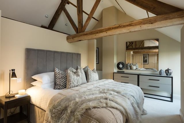 One of the bedrooms with exposed trusses and rural views