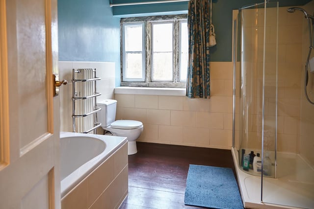 A large walk-in shower cubicle forms part of this large bathroom.