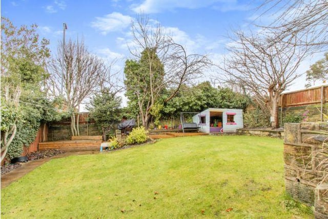 Outside is a very generously sized garden with a lawn and patio area.