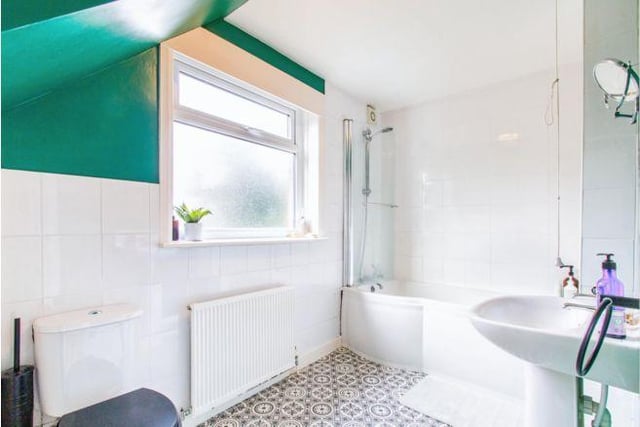 On this floor there are two bathrooms, including the large family bathroom, painted a striking green.