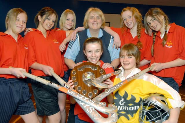 A triumphant Caedmon girls hockey team with their trophy. Players are pictured with teacher Karen Fellows.