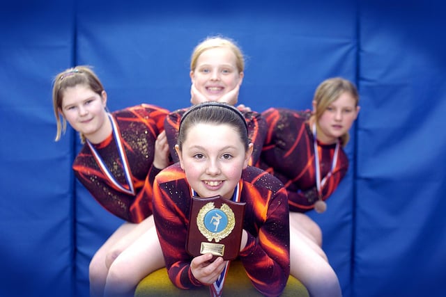 Caedmon gymnastics team win an award at a district tournament.