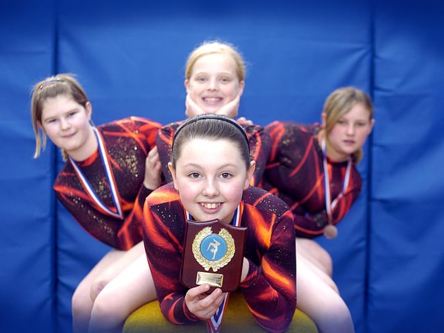 Caedmon gymnastics team win an award at a district tournament.