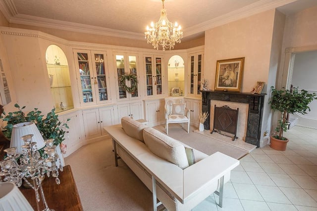 Another impressive fireplace, and hand crafted units bring interest to this reception room within the property.