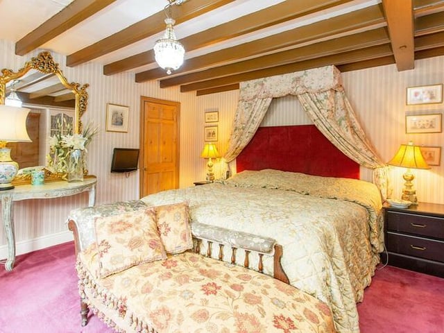 A beamed ceiling adds to the character of this double bedroom.