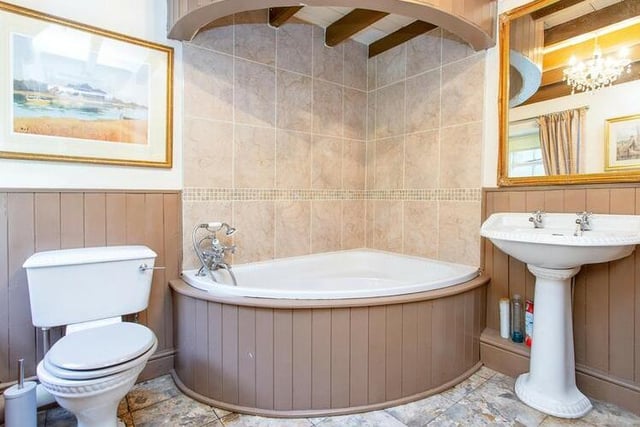 A corner bath features within this designer bathroom