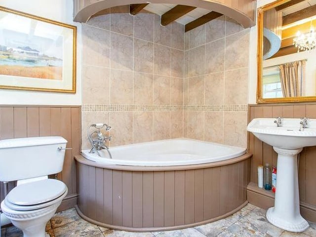 A corner bath features within this designer bathroom