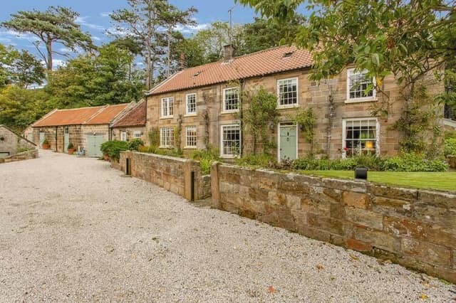 The Old Mill, with its stone walls and many windows, is a home with historic significance.