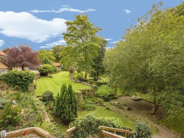 The property stands on six acres of land, that includes lawns, trees and shrubs, and borders the river known as Staithes Beck.