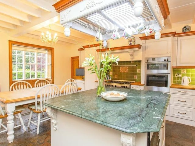 The modern, roomy kitchen has fitted units with some integral appliances.