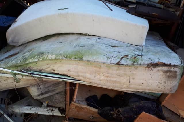 Mattresses, wooden furniture and more had pressed against Linda Burrows' fence
