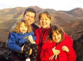 Rob, Kim and two of their daughters who are seven and 13.