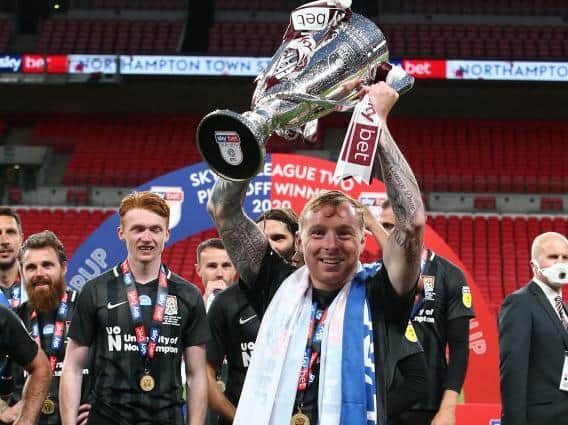 Nicky Adams holds the trophy aloft.