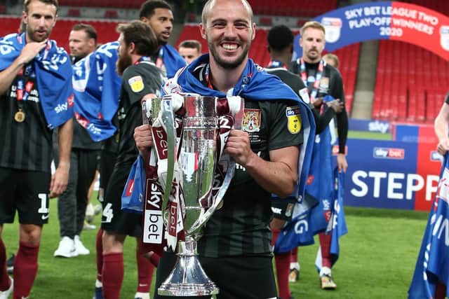 A beaming Michael Harriman with the league two play-off trophy