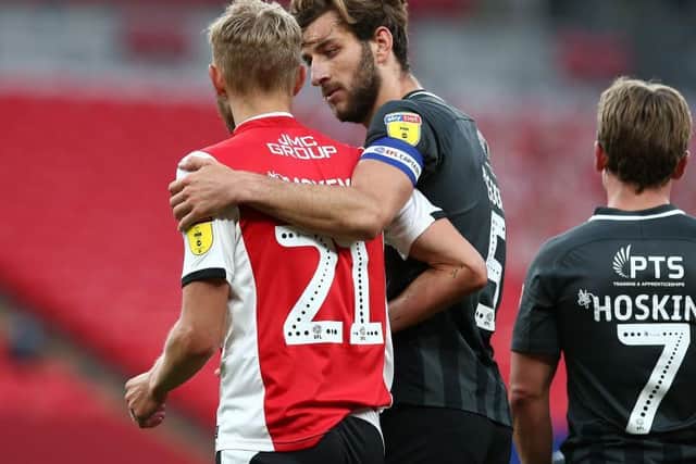 Dean Moxey is comforted by Charlie Goode after his red card at Wembley.