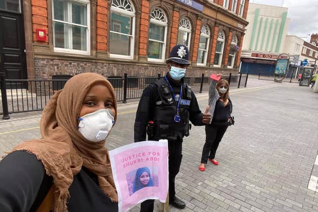 Labour borough councillor for Castle ward, Muna Cali, with a police officer and another protester at the #JusticeforShukri demonstration in Northampton. Photo: Muna Cali