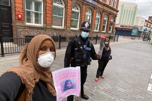 Labour borough councillor for Castle ward, Muna Cali, with a police officer and another protester at the #JusticeforShukri demonstration in Northampton. Photo: Muna Cali