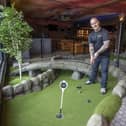 Caddy Shack general manager Peter Petter has a go at the mini-golf course