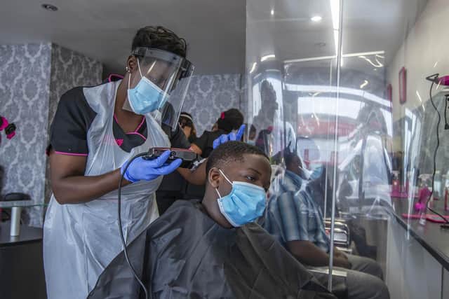 Rutendo Nyatsine cuts a boy's hair at Flowey Beauty Parlour