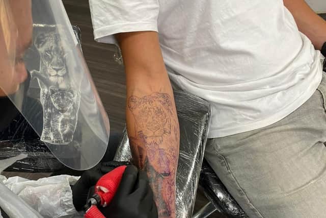 Artist Lorand Szakacs works on a customer's tattoo at Revelation Tattoo Studio