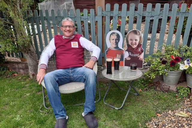 Richard back home with cutouts of his dad and granddaughter Aiofe after his marathon tour