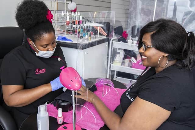 Florence Nyatsine gives Belinda Fumai a manicure at Flowey Beauty Parlour