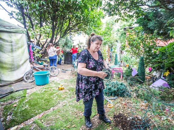 Tracey Thomas pictured in her garden, which is being transformed this week following help from volunteers. Pictures by Kirsty Edmonds.