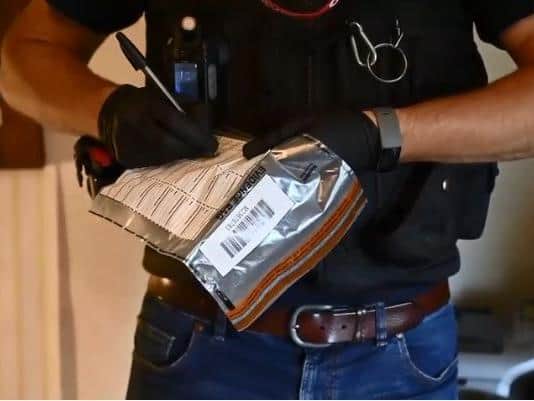 Police bag up evidence during Wednesday's drugs raid in Kettering. Photo: Northamptonshire Police
