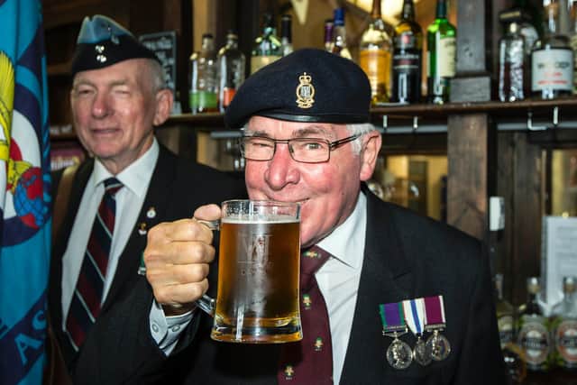 Peter Dimmock drinking from one of the tankards that has been engraved by the regimental sergeant of the Royal Signals.