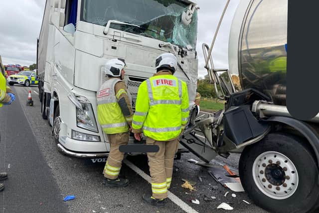 Fire crews examine the damage from Thursday's collision which closed the M1 for 2 hours. Photo: Northamptonshire Police