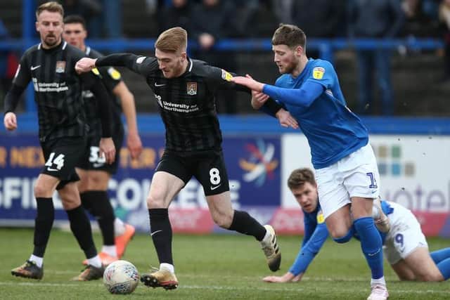 Former Macclesfield centre-back Fraser Horsfall challenges Ryan Watson during Northampton's win at Moss Rose last season.
