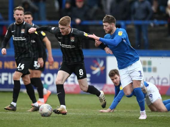 Former Macclesfield centre-back Fraser Horsfall challenges Ryan Watson during Northampton's win at Moss Rose last season.