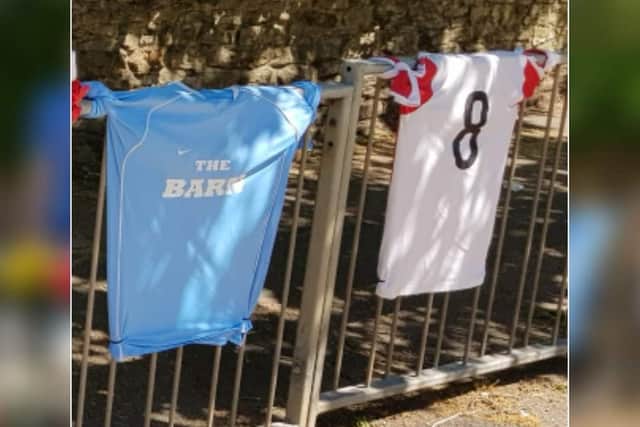 The white Standens Barn FC shirt was fastened to the railings near to Norman Road and Wellingborough Road with cable ties.