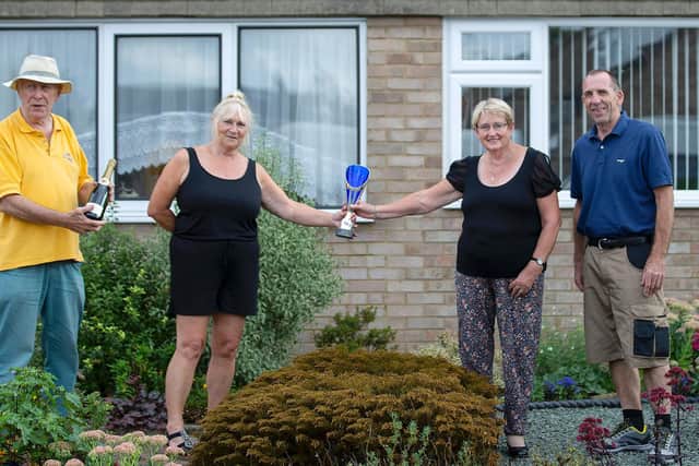 Chris Westley and Alan and Carol Garrett with their front garden winners trophy. Photo: Kirsty Edmonds.