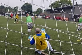 David Poole faces a shot in goal during training with Moulton Masters Walking Football Club