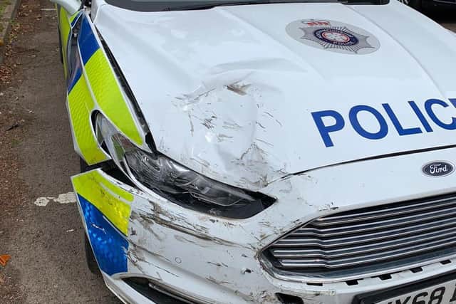 Several police cars were left with visible damage to the bumpers after the incident.