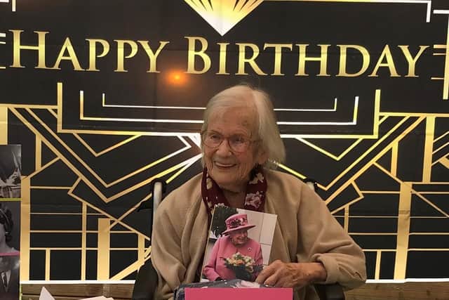 Joyce Wooding pictured on her 109th birthday with her card from HM The Queen.
